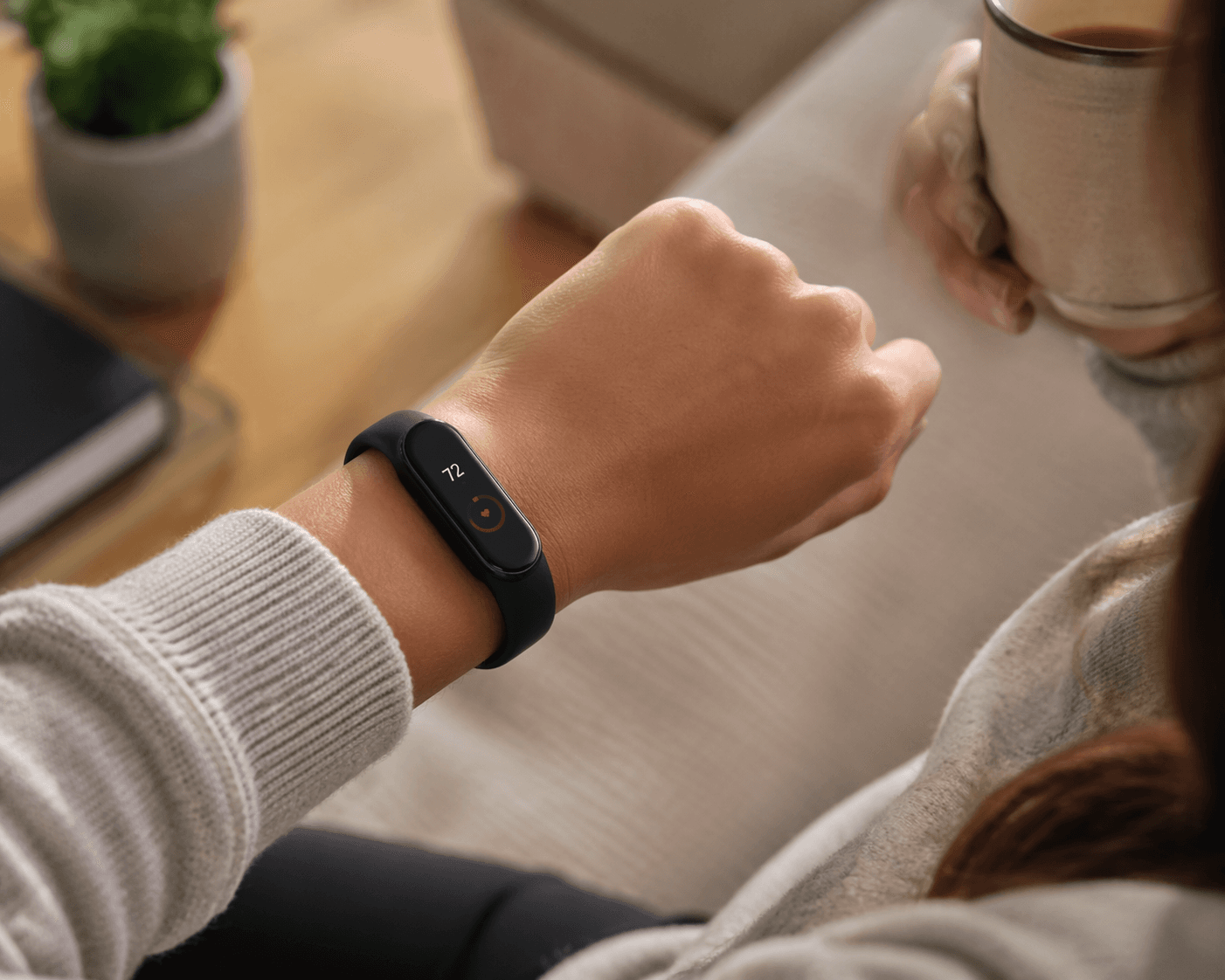 Woman wearing a slim fitness tracker watch comfortably on her wrist in natural daylight