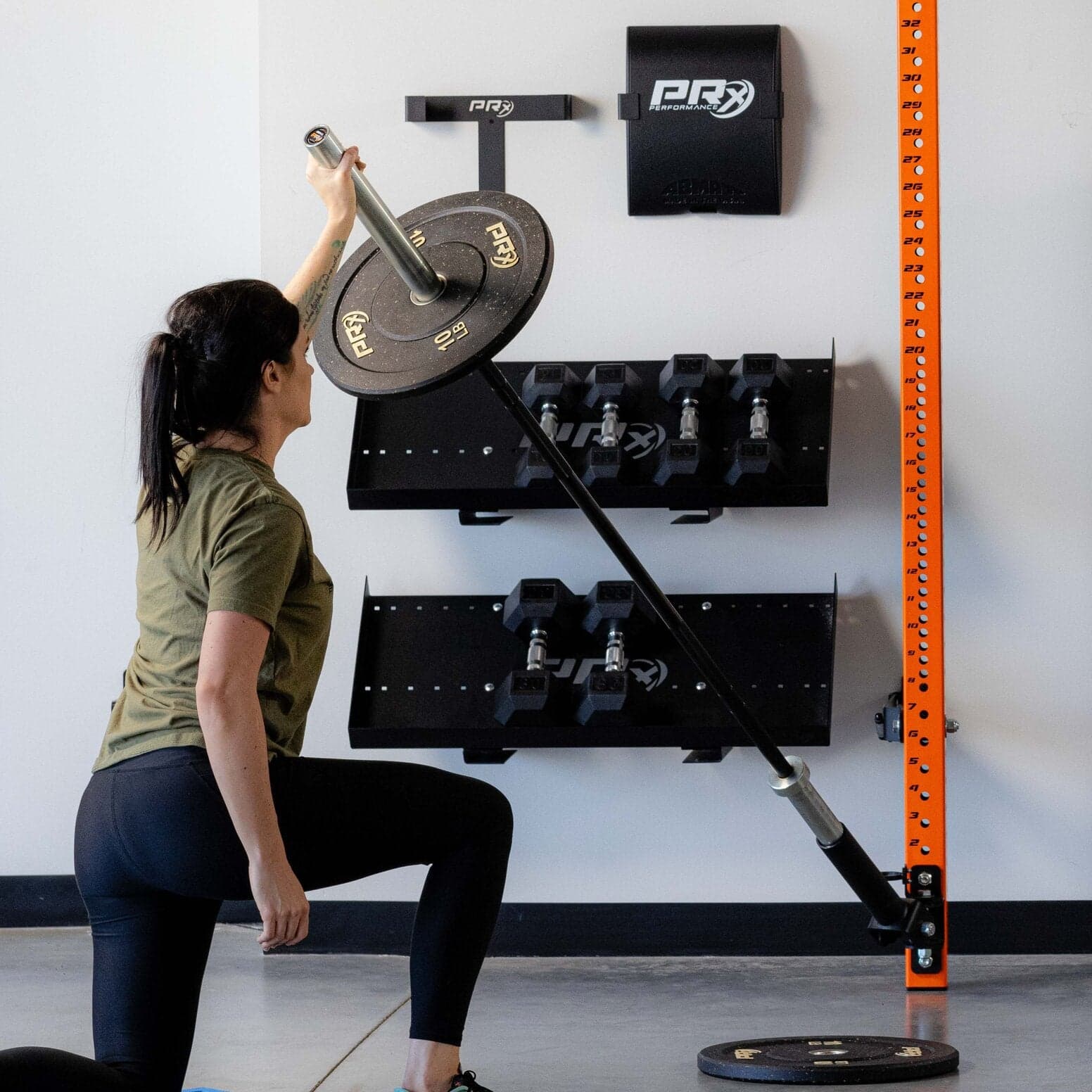 PRx Profile PRO folding squat rack mounted on a wall in a home gym
