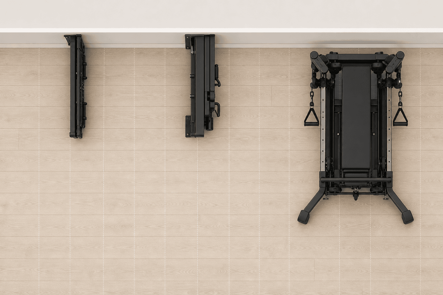 Top-down floor plan silhouettes of three equipment footprints: a thin 9-inch folded rack, a 15-inch wall-mounted unit, and a larger 31-by-28.5-inch cable tower, over a light wood floor grid.