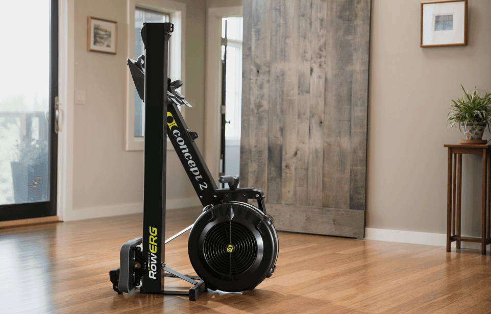 Concept2 RowErg rowing machine stored upright against a wall