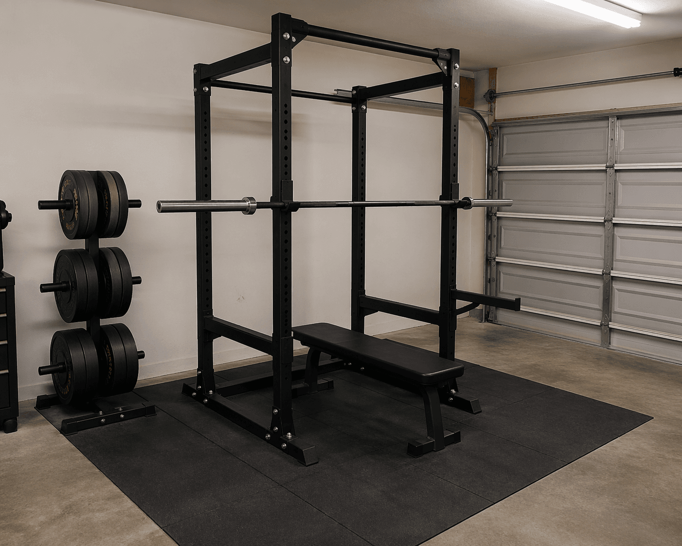 Budget garage gym with power rack, barbell, flat bench, bumper plates, and rubber matting