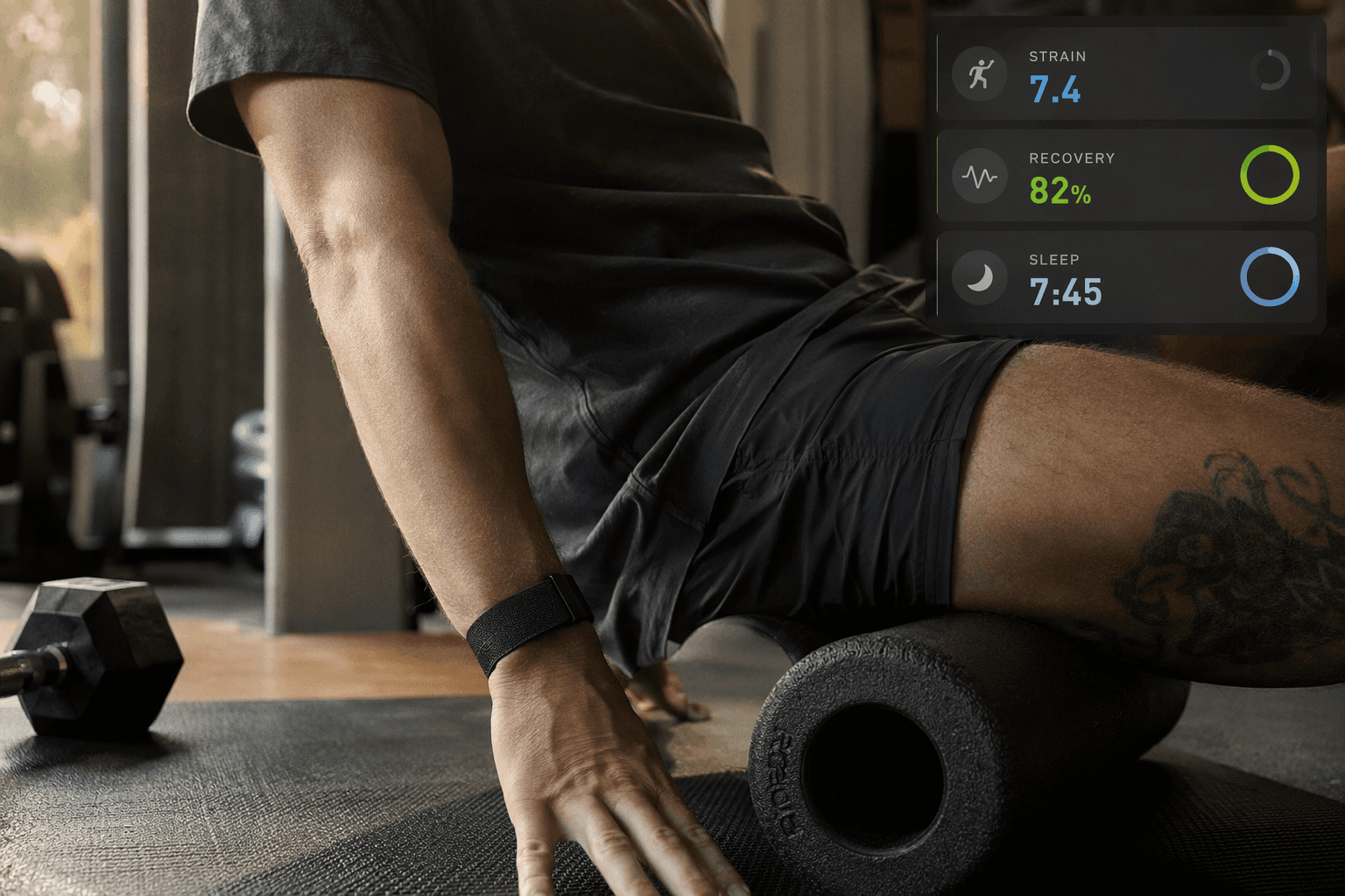 A Whoop 5.0 fabric band on a wrist as the user foam rolls on a yoga mat in a home gym, with a faint app overlay showing Strain, Recovery, and Sleep scores.