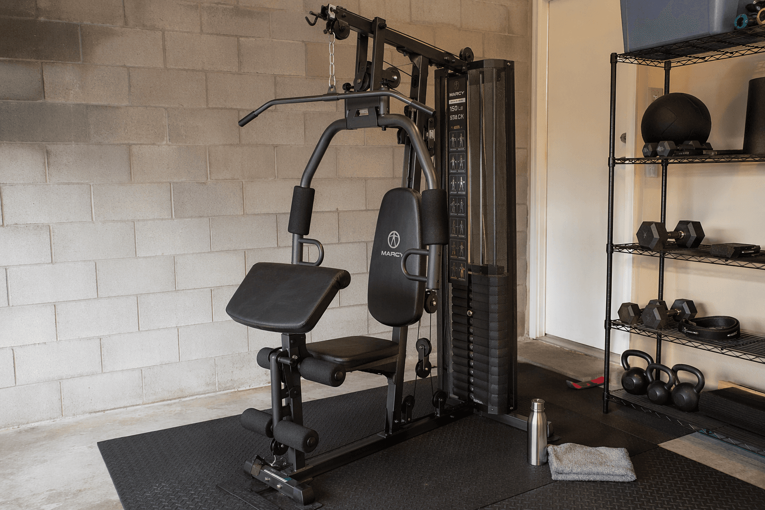 Marcy 150lb stack home gym in a garage gym corner showing the weight stack, dual-action press arms, preacher curl pad, and leg developer.