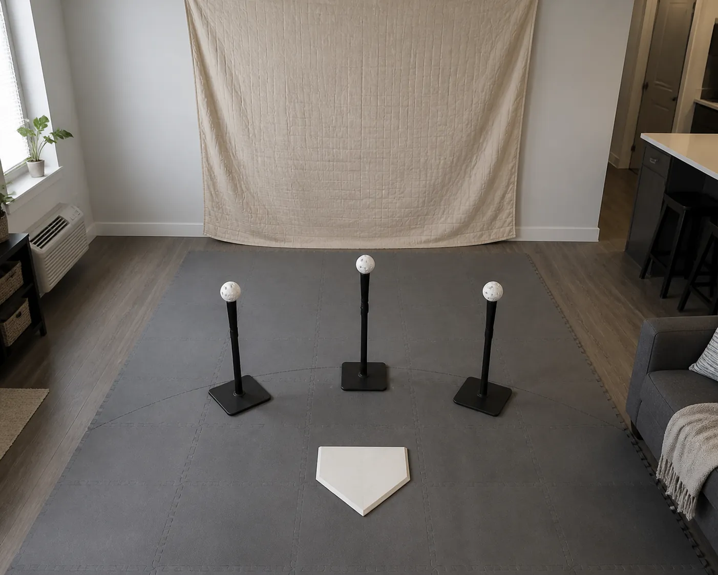 Indoor batting tee showing front, middle, and inside contact positions with wiffle balls near a blanket backstop and floor mat