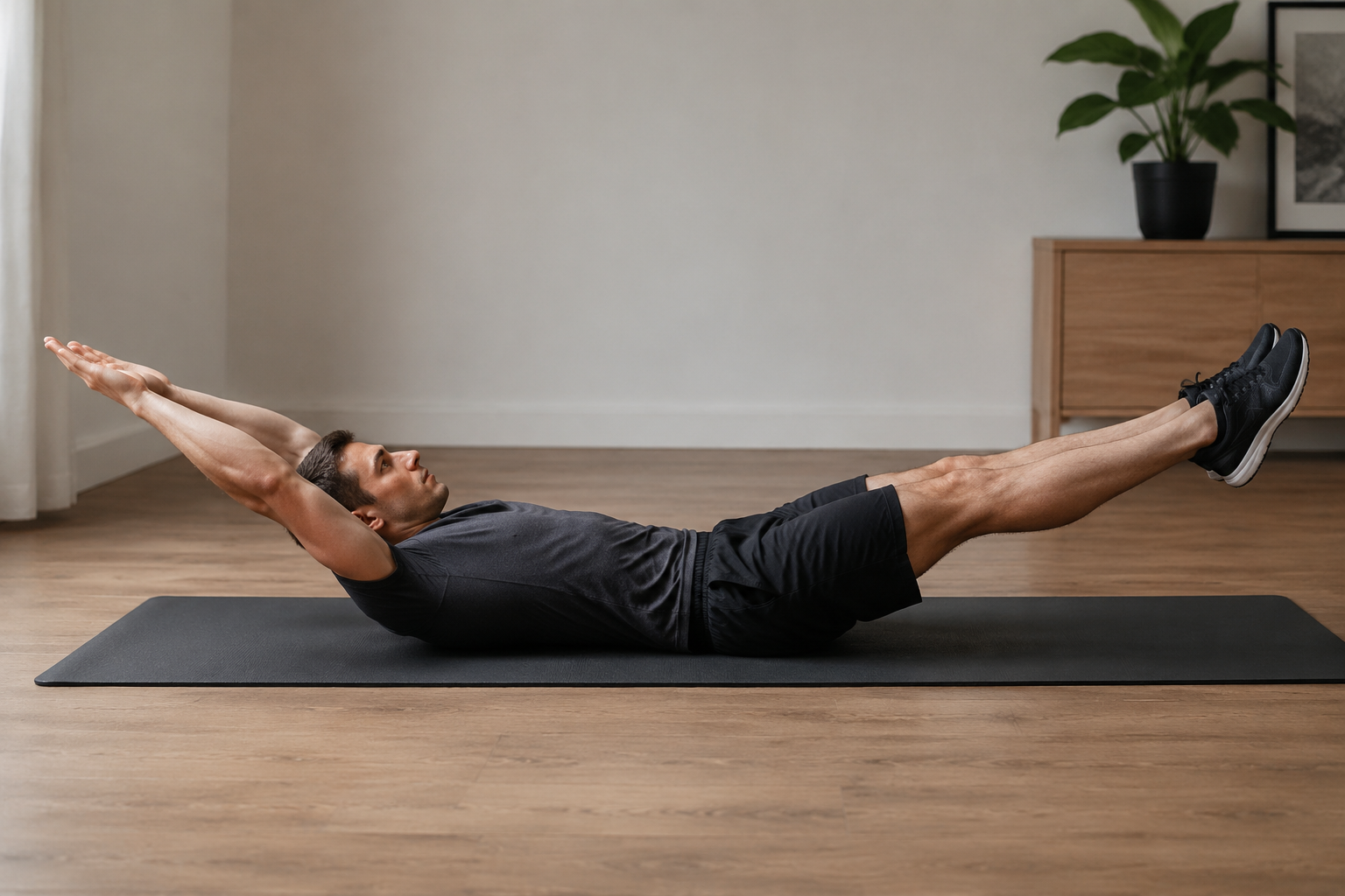 Person holding a hollow body position on a mat at home.
