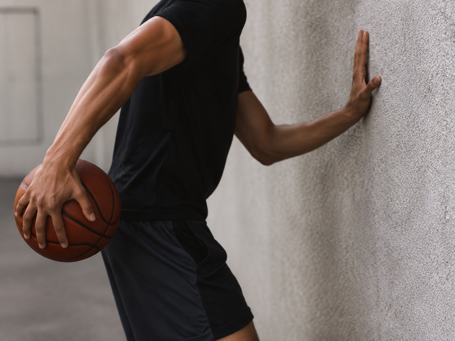 Close-up of a basketball player performing a wall-tap ball-handling drill