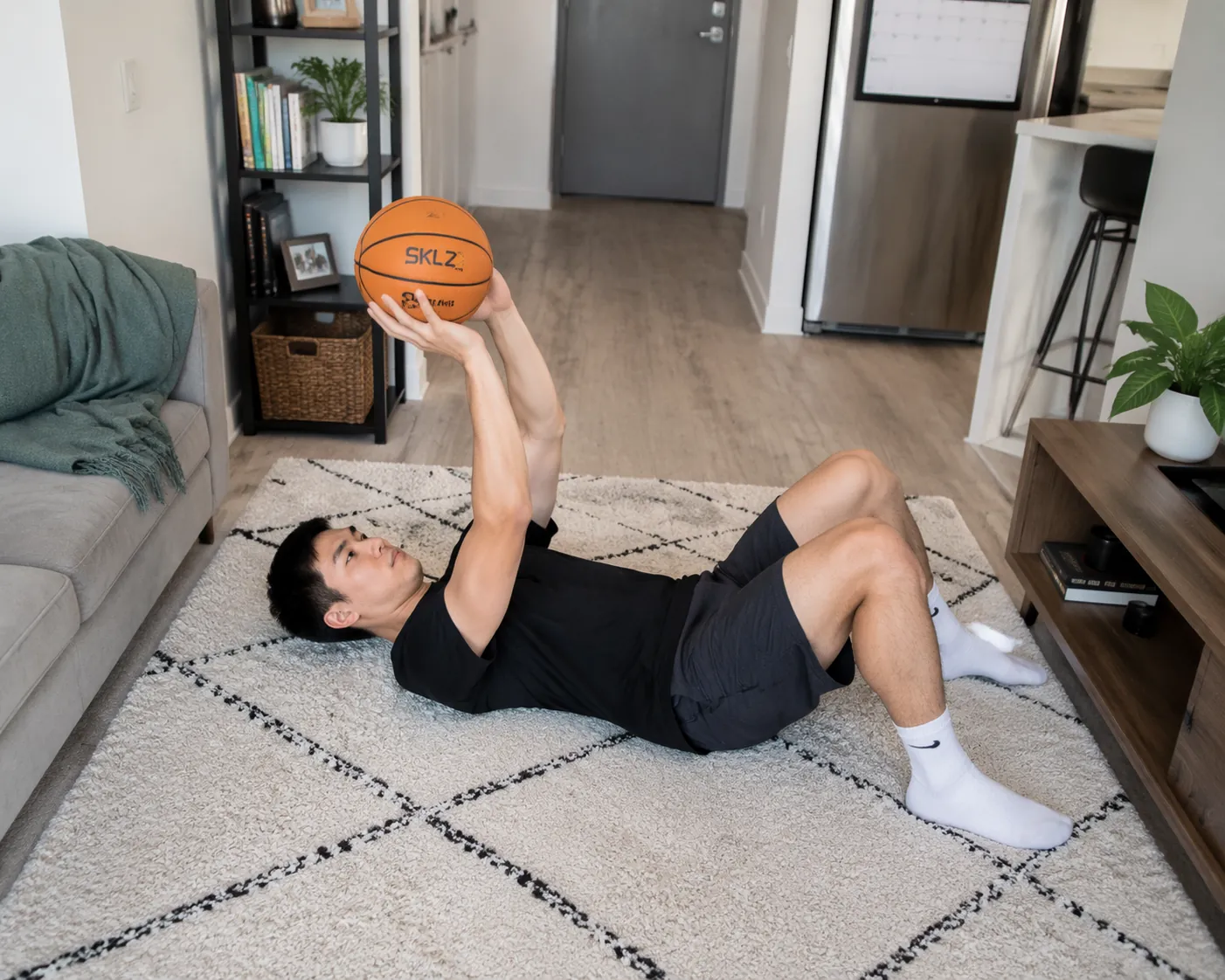 Person lying on a carpeted apartment floor practicing quiet basketball shooting form with a foam ball