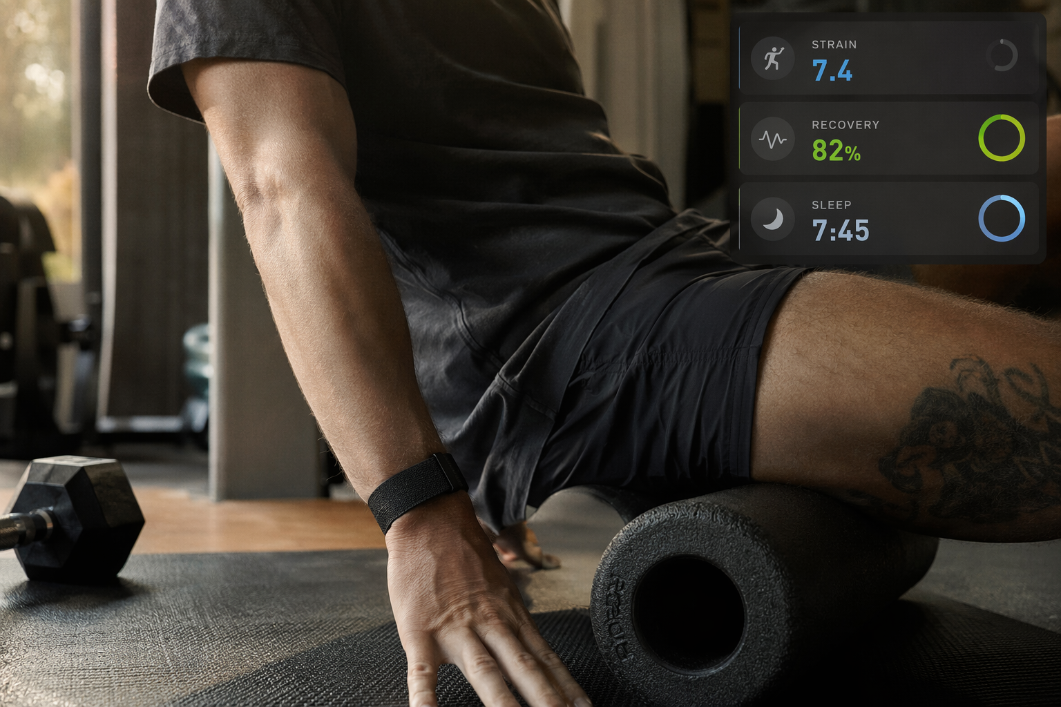 A Whoop 5.0 fabric band on a wrist as the user foam rolls on a yoga mat in a home gym, with a faint app overlay showing Strain, Recovery, and Sleep scores.