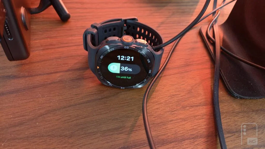 The Galaxy Watch Ultra 2 on a magnetic charging puck during a timed charging test.