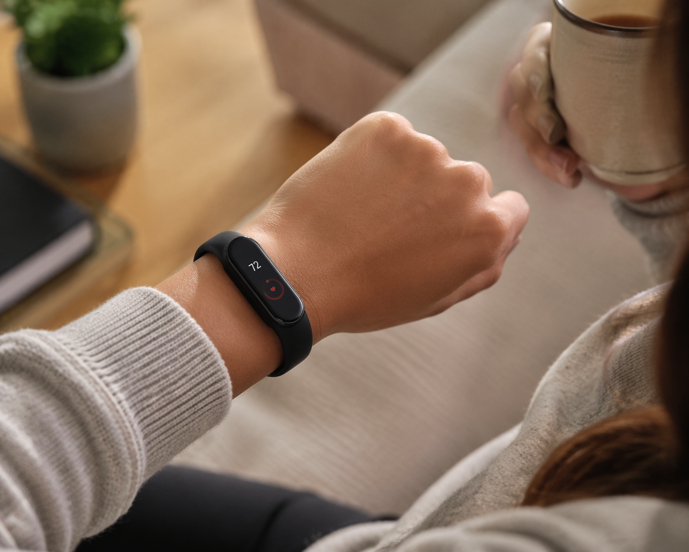 Woman wearing a slim fitness tracker watch comfortably on her wrist in natural daylight