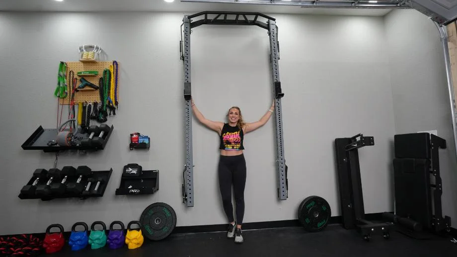 PRx Profile PRO foldable squat rack folded flat against a garage wall