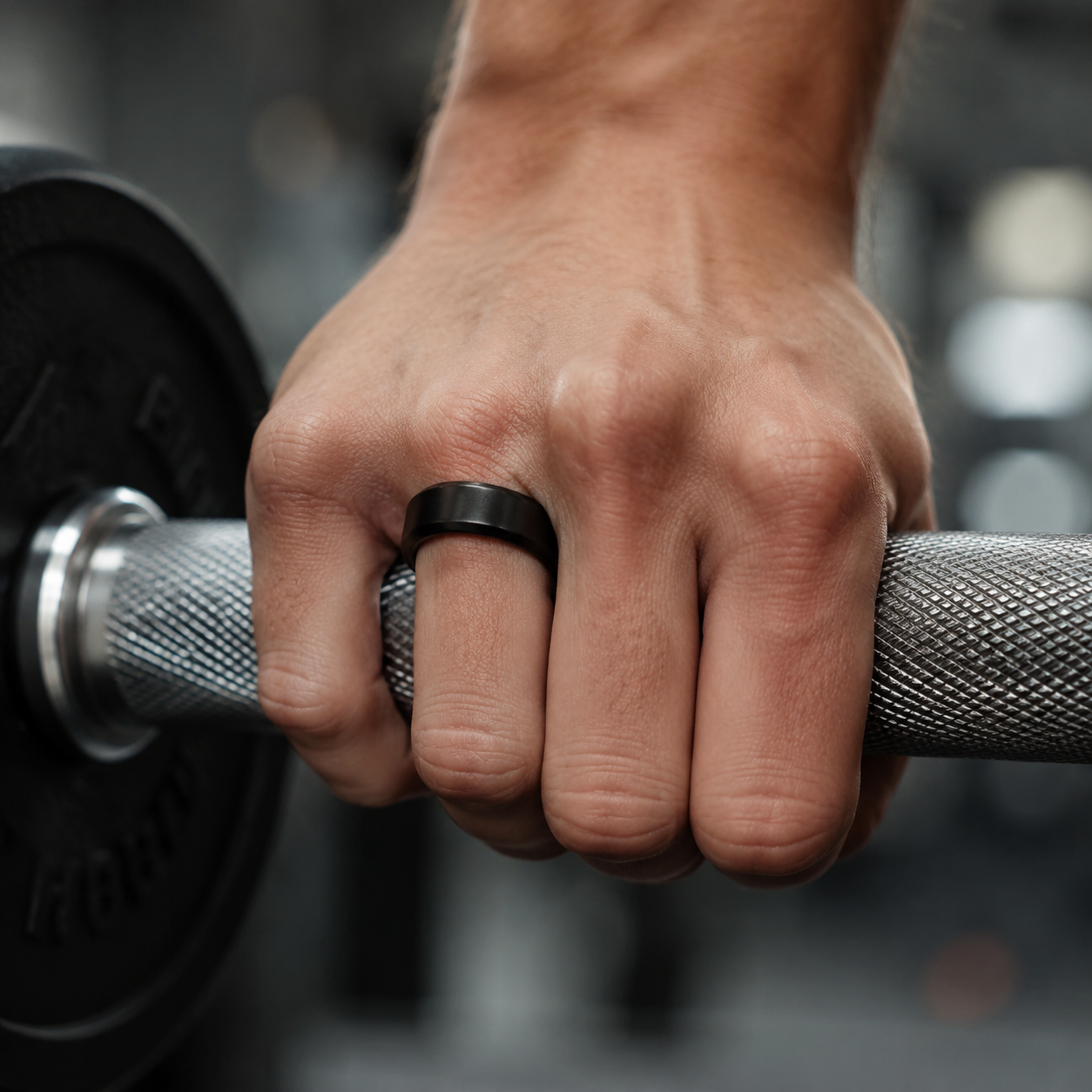 Oura Ring worn while gripping a knurled dumbbell handle