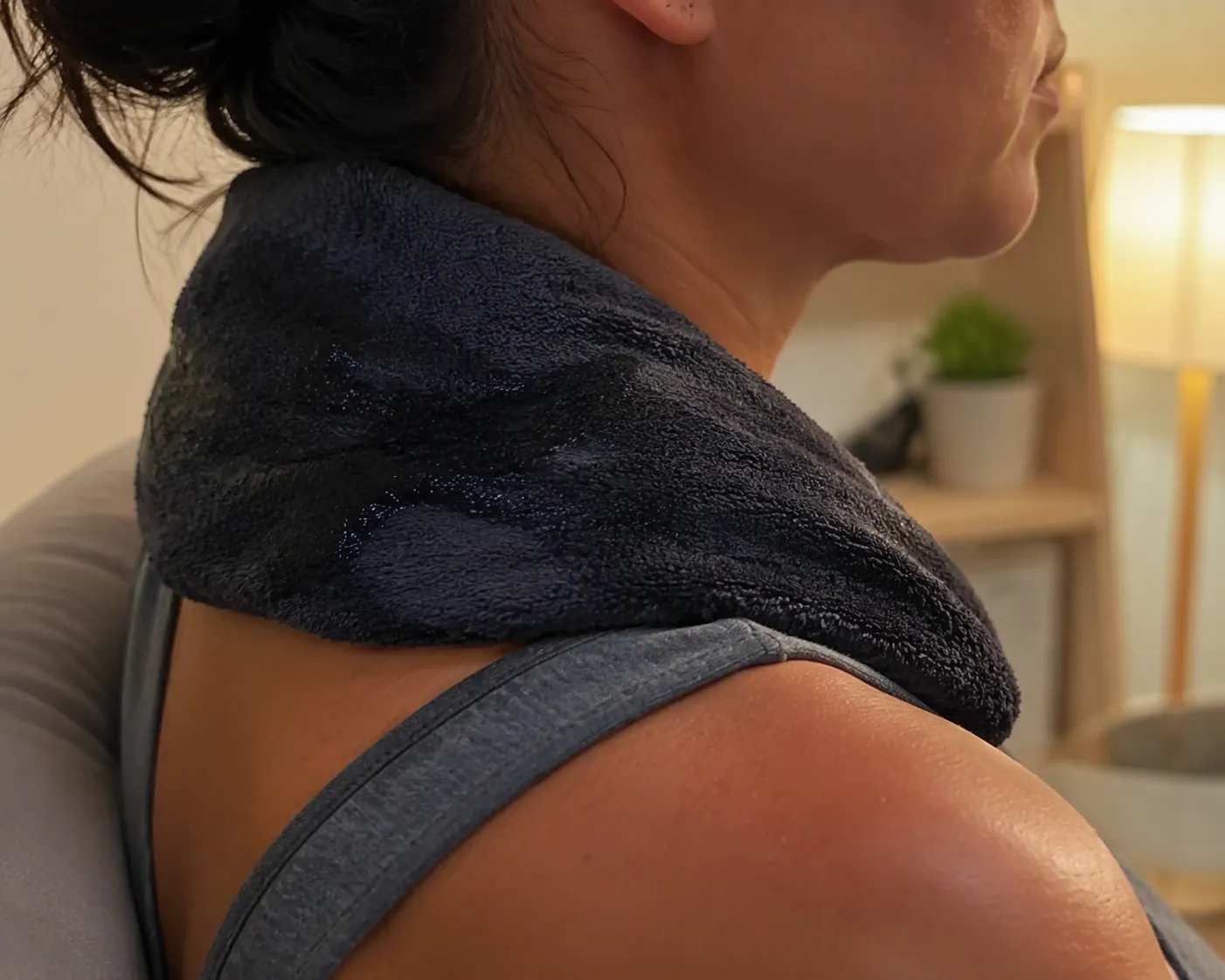 Cold damp towel wrapped around the back of the neck after a home workout