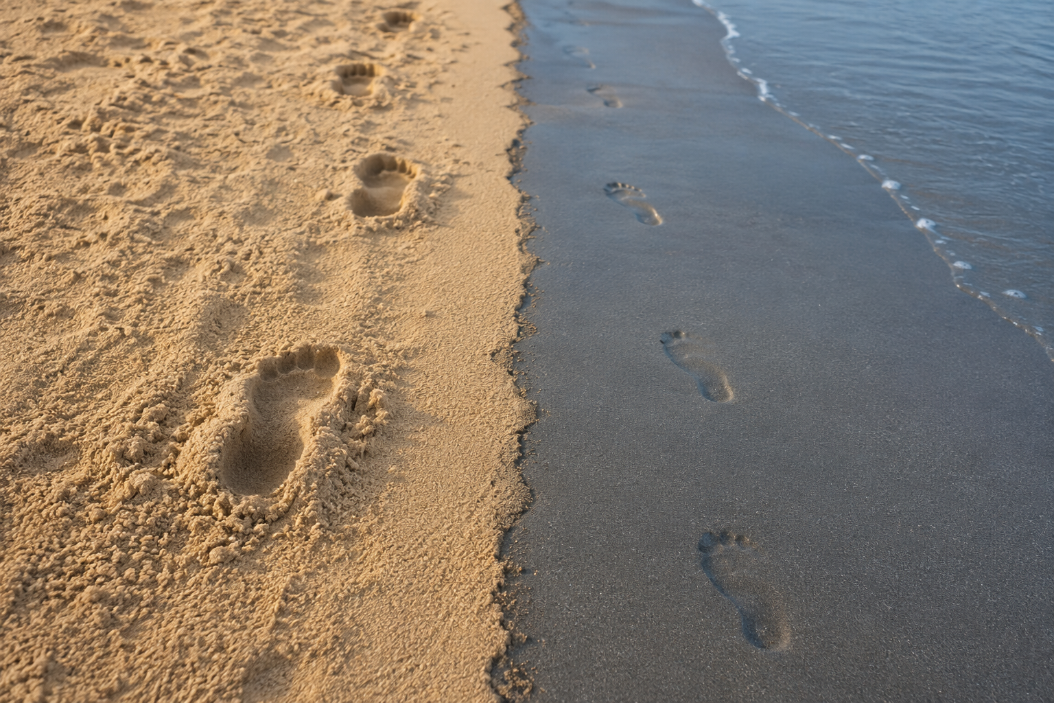 Loose dry sand contrasted with firm packed wet sand near the waterline