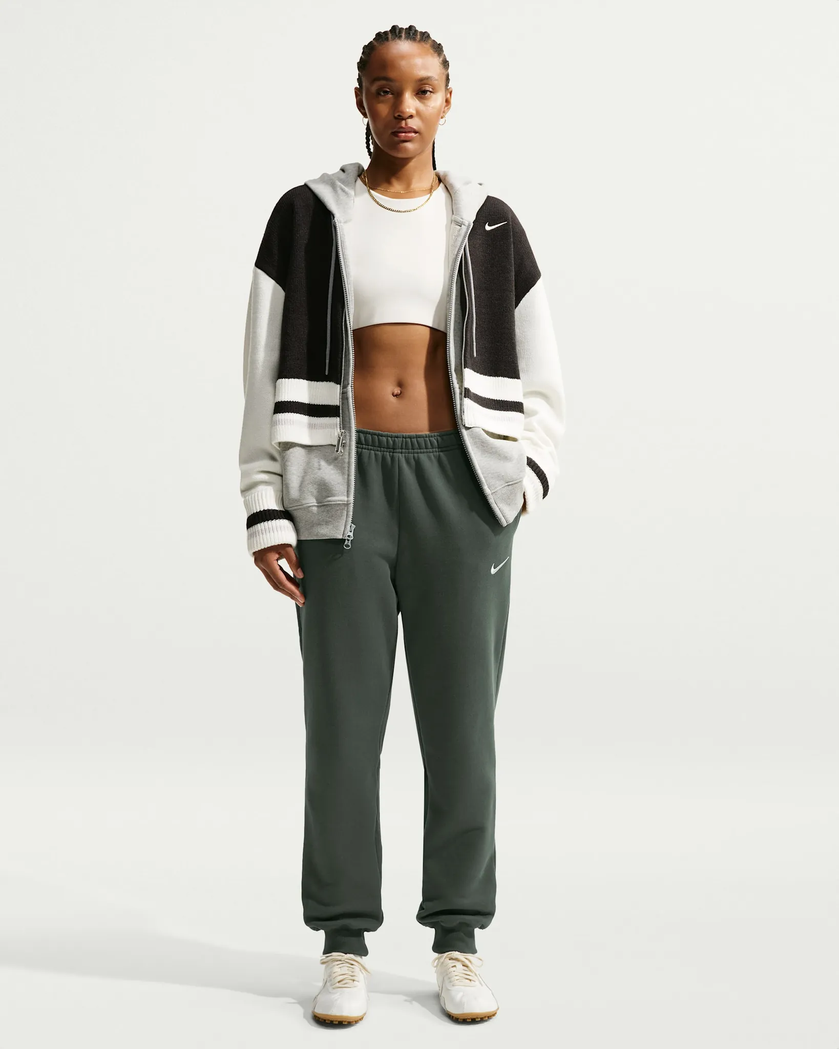 Official Nike product photo of Studio Fleece medium-weight mid-rise joggers showing ribbed cuffs and brushed fleece texture