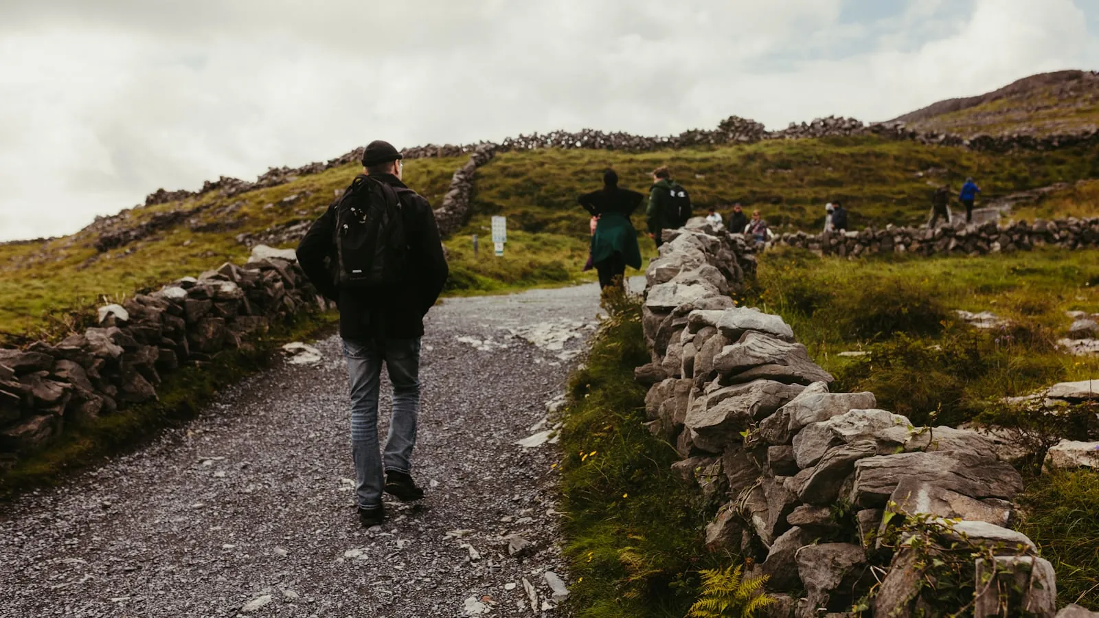 Two people walking on an easy level gravel trail in open daylight