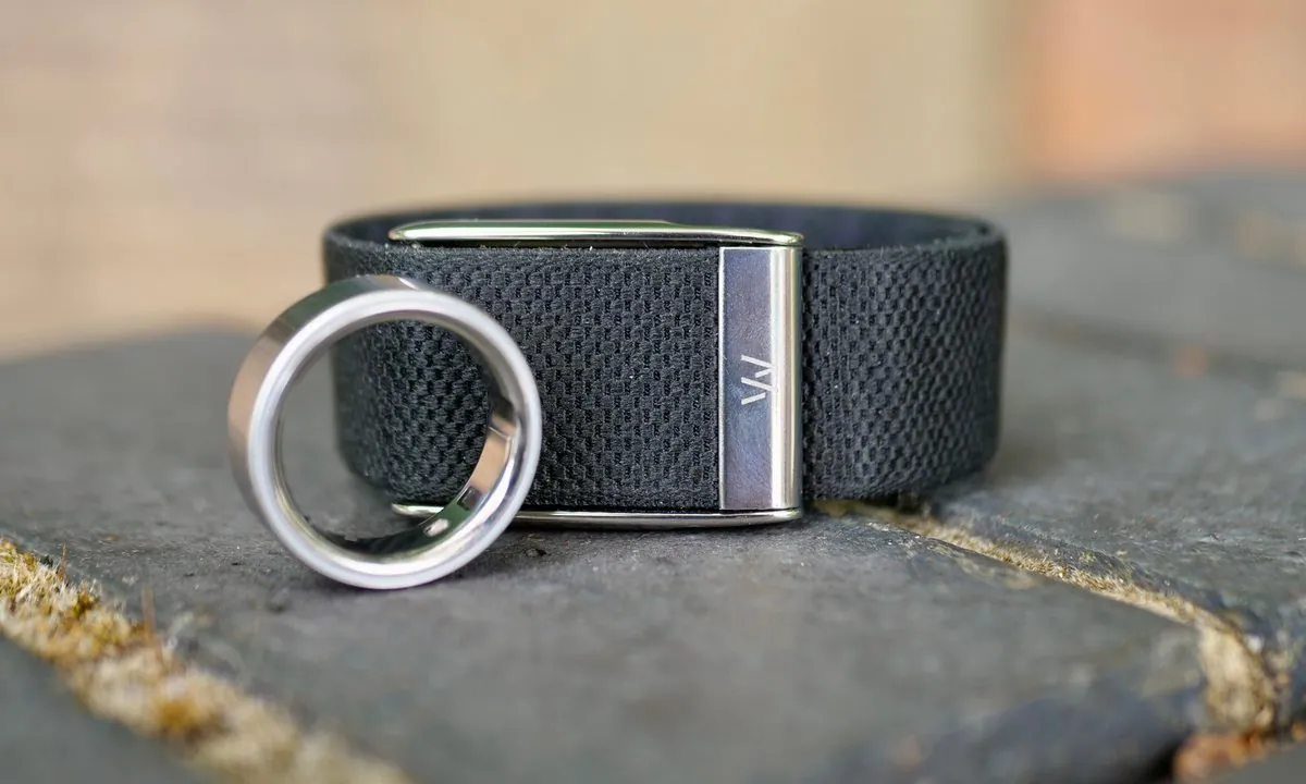 WHOOP 5.0 screenless band beside an Oura Ring 4