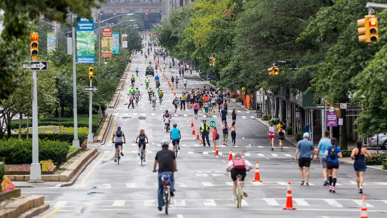Car-free New York City street during Summer Streets with runners, cyclists, and pedestrians using the open roadway