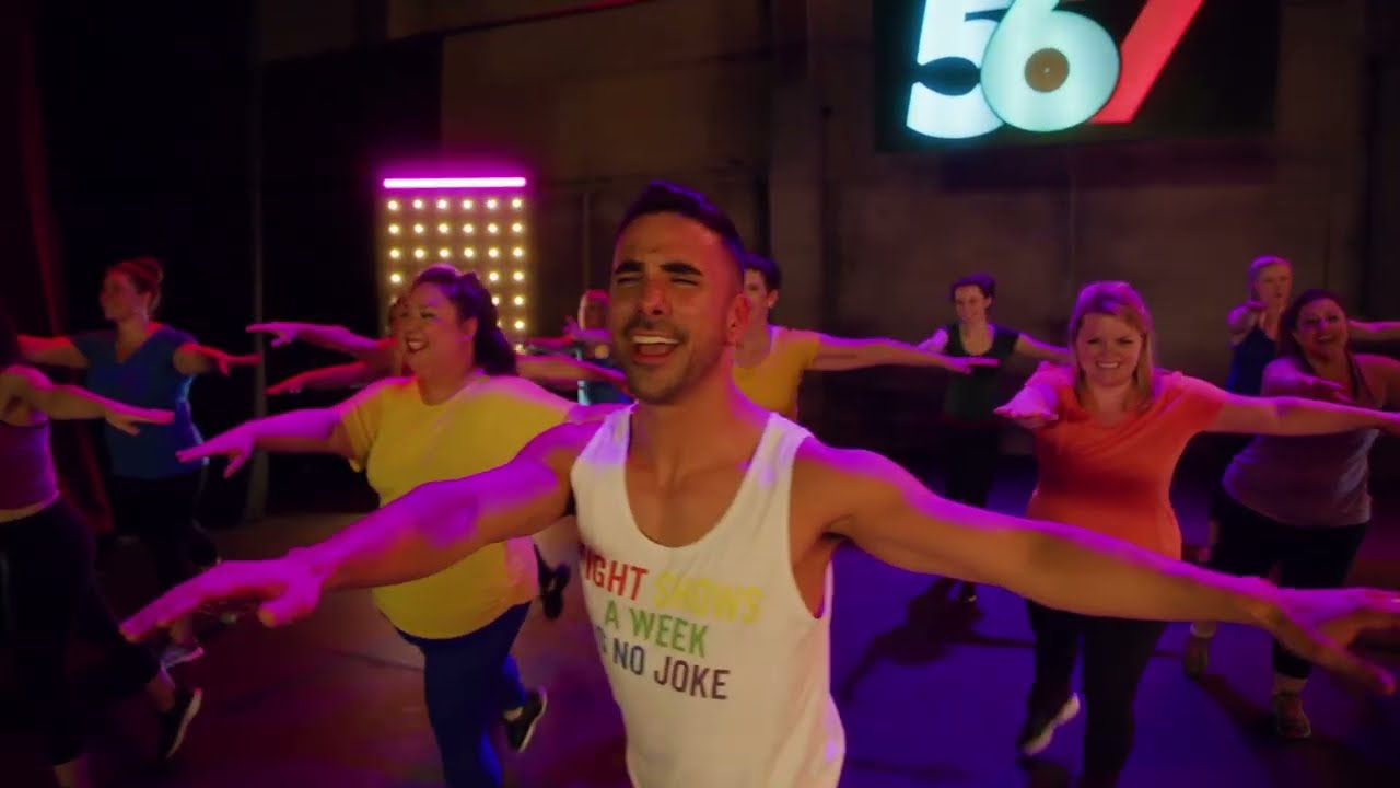 Joseph Corella leading a 567BROADWAY dance workout class in a bright studio
