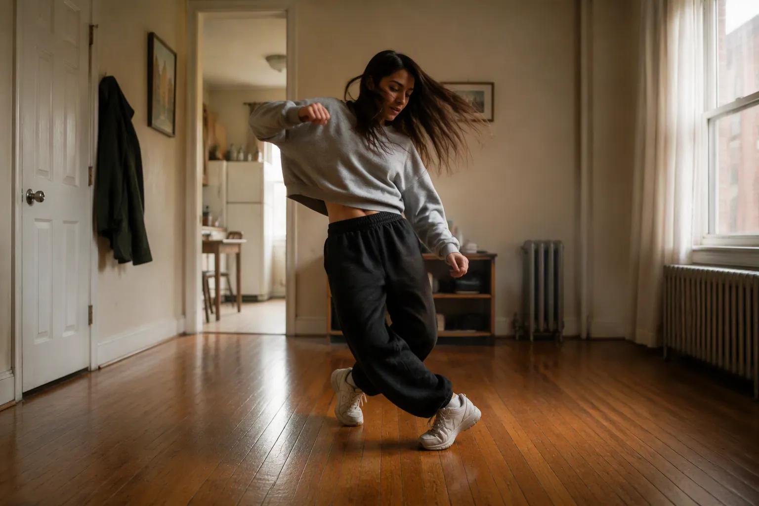 A beginner doing a hip hop dance workout in a small cleared living room