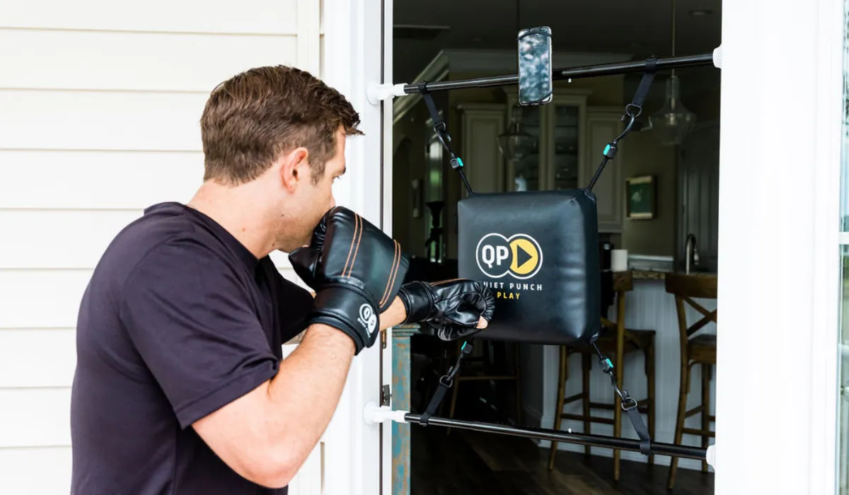 Doorway-mounted punching bag installed in a compact apartment room with no floor contact