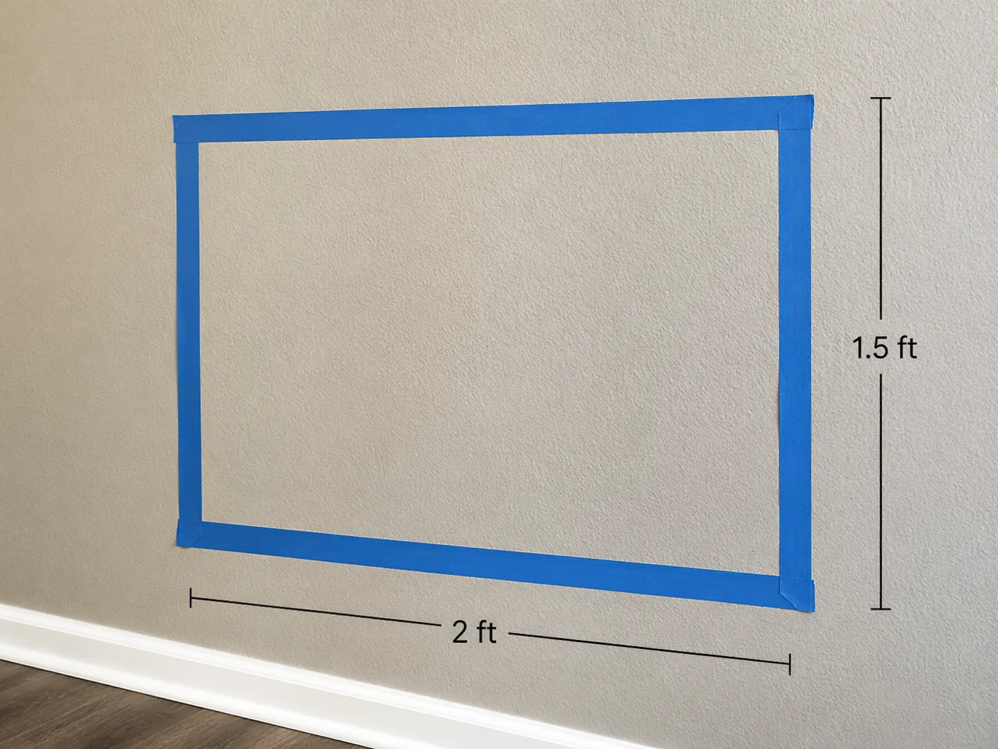 Blue painter's tape rectangle target on an apartment wall