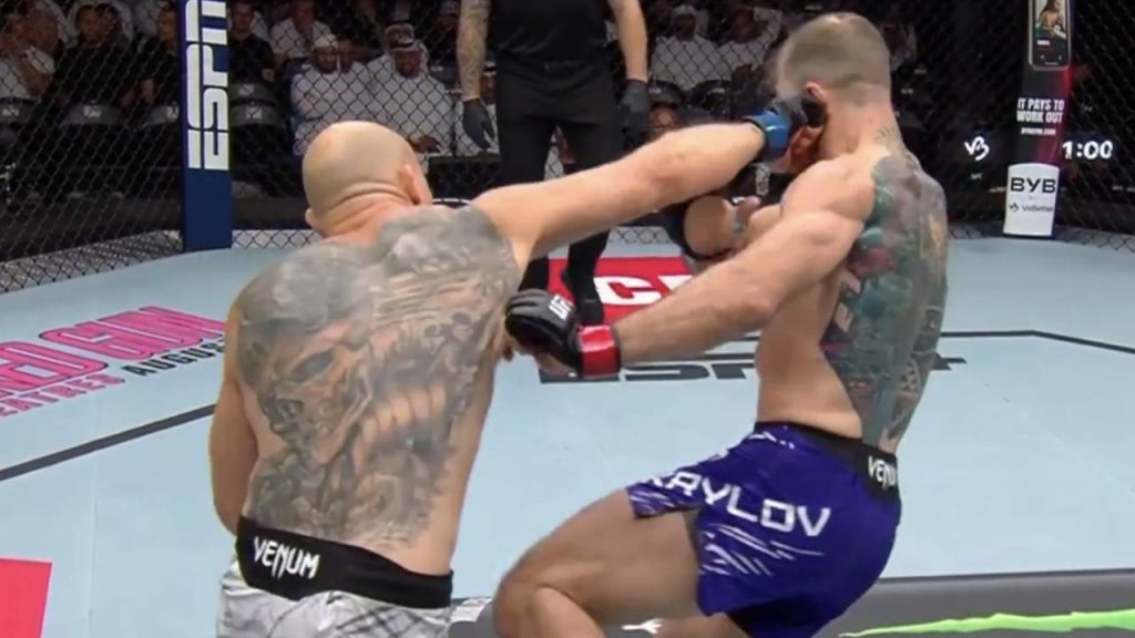 Bogdan Guskov landing a heavy right hand on Nikita Krylov while driving forward in the octagon