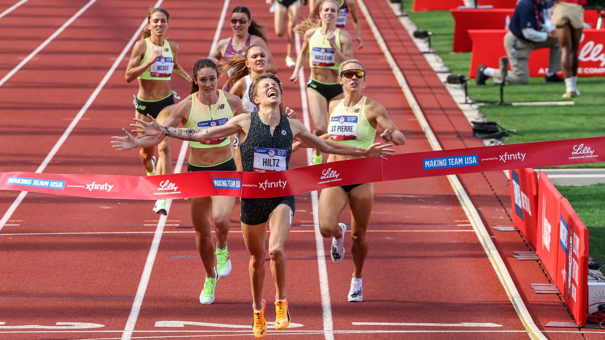 Nikki Hiltz racing at the U.S. Olympic Trials 1500m with the stadium crowd behind them