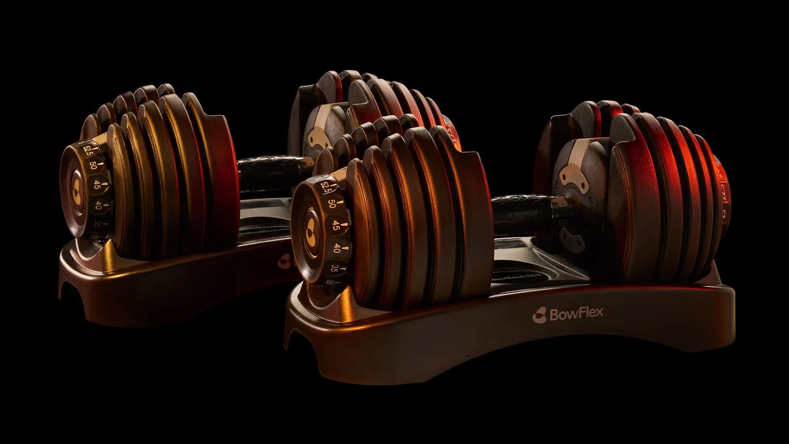 Pair of Bowflex Results Series 552 adjustable dumbbells in black and orange