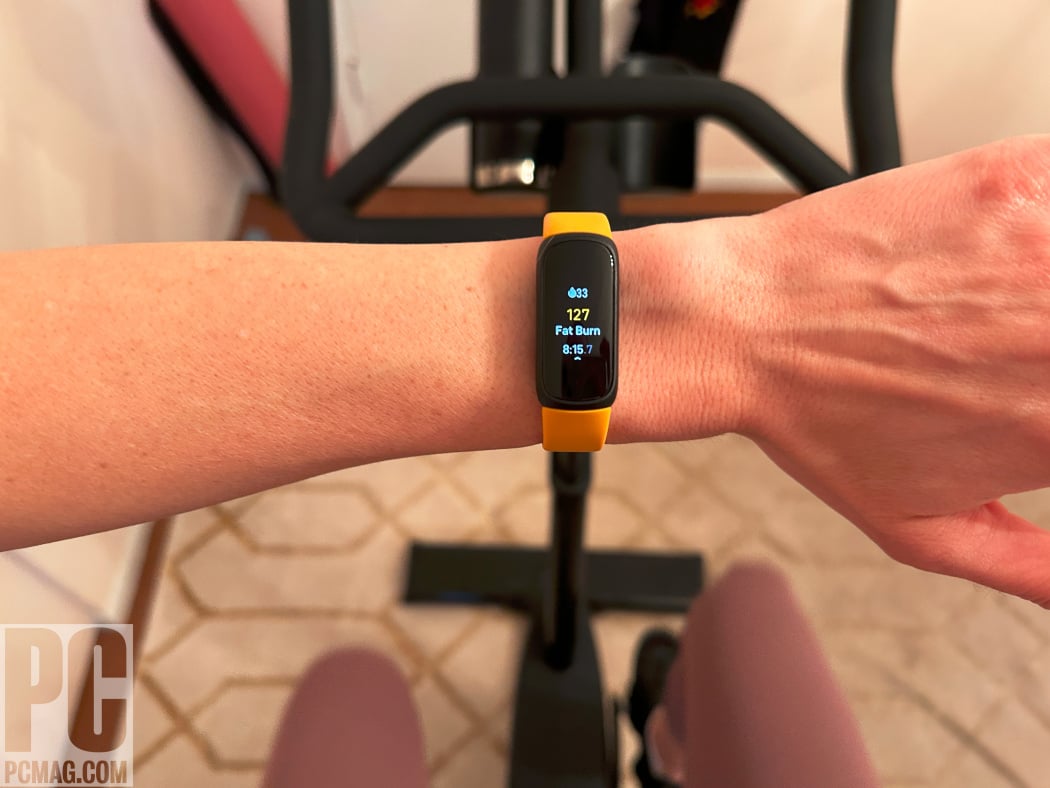 Fitbit Inspire 3 fitness tracker worn on a wrist showing a slim AMOLED display