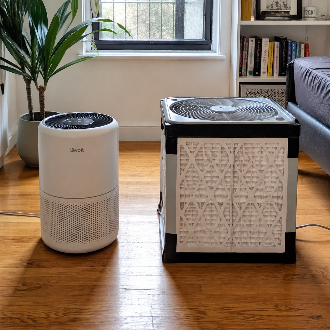 Commercial HEPA air purifier beside a DIY Corsi-Rosenthal box made with a box fan and MERV 13 filters