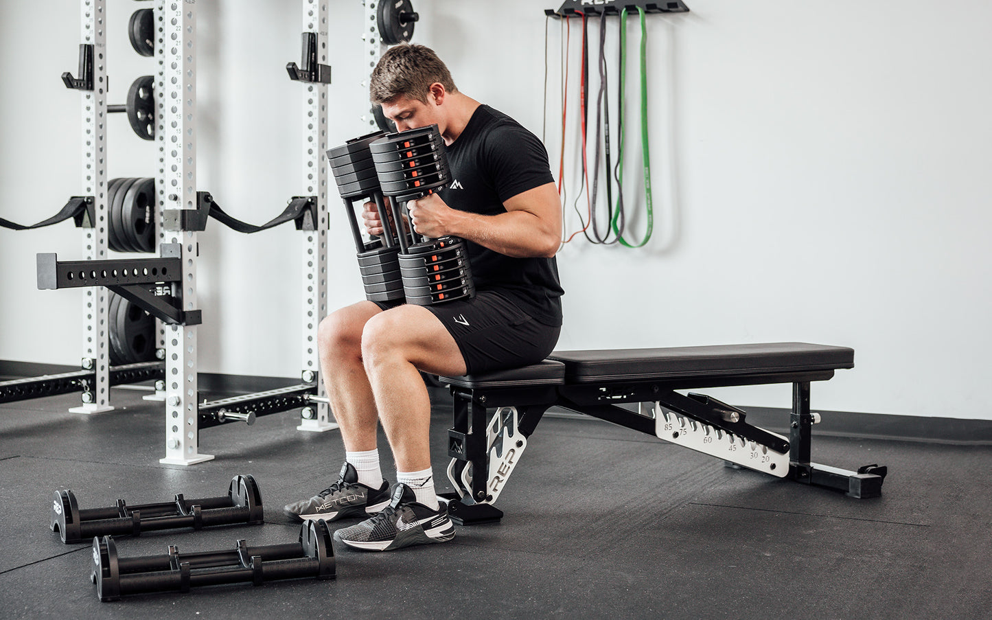 REP QuickDraw adjustable dumbbell on its cradle in a bright home setting